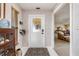 Inviting foyer featuring a decorative glass door, patterned rug, and seamless transition to the living area at 24398 Treasure Island Blvd, Punta Gorda, FL 33955