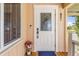 Elegant front entrance with a decorative glass door, complemented by a charming porch and stylish accents at 24398 Treasure Island Blvd, Punta Gorda, FL 33955