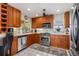 Well-lit kitchen featuring stainless steel appliances and ample wooden cabinetry at 24398 Treasure Island Blvd, Punta Gorda, FL 33955