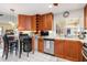 Kitchen with stainless appliances, and cabinetry with wine rack and breakfast bar at 24398 Treasure Island Blvd, Punta Gorda, FL 33955