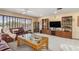 Bright living room boasting large windows, comfortable seating, and a stylish entertainment center for relaxation at 24398 Treasure Island Blvd, Punta Gorda, FL 33955