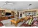Spacious living area with natural light, comfortable seating, and a media center with ample storage space at 24398 Treasure Island Blvd, Punta Gorda, FL 33955