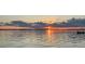 Stunning sunset view over the tranquil lake enhances this property's serene and picturesque appeal at 24398 Treasure Island Blvd, Punta Gorda, FL 33955