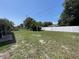 Large backyard with a white fence and lush greenery, ideal for outdoor activities at 2443 Lake View Blvd, Port Charlotte, FL 33948