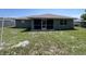 Backyard view featuring a screened lanai, and a big yard at 2443 Lake View Blvd, Port Charlotte, FL 33948