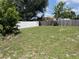Expansive backyard with lush green grass and mature trees, perfect for relaxation and recreation at 2443 Lake View Blvd, Port Charlotte, FL 33948