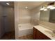 Bathroom with tiled walk-in shower, garden tub, wood vanity and granite countertop at 2443 Lake View Blvd, Port Charlotte, FL 33948