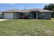 Charming home with a well-manicured lawn, adding to its curb appeal at 2443 Lake View Blvd, Port Charlotte, FL 33948