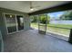 Spacious screened lanai with tile flooring and a view of the backyard and trees at 2443 Lake View Blvd, Port Charlotte, FL 33948