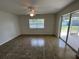 Bright living room featuring tile flooring, ceiling fan and sliding glass doors to the outdoors at 2443 Lake View Blvd, Port Charlotte, FL 33948
