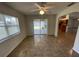 View of the living room with tile flooring and open doorway to the kitchen area at 2443 Lake View Blvd, Port Charlotte, FL 33948