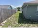 Side yard with a wooden fence and grassy area, providing a private outdoor space at 2443 Lake View Blvd, Port Charlotte, FL 33948