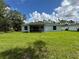 Backyard view showcasing the house and green lawn at 2451 Waller Rd, North Port, FL 34288