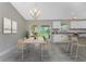 Bright dining area featuring modern furniture, a chandelier, and sliding doors leading to an outdoor space at 2451 Waller Rd, North Port, FL 34288