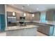 Well-equipped kitchen with stainless steel appliances, granite countertops, a kitchen island, and ample cabinet space at 2451 Waller Rd, North Port, FL 34288