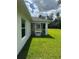 Home's backyard featuring a screened lanai and lush green grass at 2461 Waller Rd, North Port, FL 34288