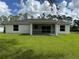 Lush green backyard featuring a screened lanai and ample space for outdoor activities at 2461 Waller Rd, North Port, FL 34288