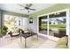 Comfortable seating on this screened-in porch offers relaxing backyard vistas at 2461 Waller Rd, North Port, FL 34288