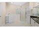 Bright bathroom showcasing a walk-in tub, a glass enclosed shower, and granite countertop with cabinets at 25555 Heritage Lake Blvd # 27, Punta Gorda, FL 33983