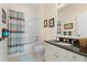 Bathroom with vanity and shower/tub featuring tiled walls and decorative art at 25555 Heritage Lake Blvd # 27, Punta Gorda, FL 33983