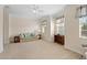 Large bedroom with plush carpet, windows with blinds and curtains and neutral wall colors at 25555 Heritage Lake Blvd # 27, Punta Gorda, FL 33983