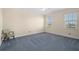Bright bedroom with blue carpet, crown molding, ceiling fan, and views of the outdoors at 25555 Heritage Lake Blvd # 27, Punta Gorda, FL 33983