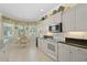 Well-appointed kitchen with white cabinets, granite countertops, stainless appliances, and tile flooring with breakfast nook at 25555 Heritage Lake Blvd # 27, Punta Gorda, FL 33983