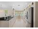 Modern kitchen featuring white cabinetry, stainless steel appliances, granite countertops, and tiled flooring at 25555 Heritage Lake Blvd # 27, Punta Gorda, FL 33983