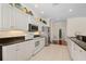 Spacious kitchen featuring white cabinetry, stainless steel appliances, and granite countertops, with convenient access to the bathroom at 25555 Heritage Lake Blvd # 27, Punta Gorda, FL 33983