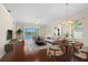 An open-concept living and dining area showcasing wood floors and sliding doors with water views at 25555 Heritage Lake Blvd # 27, Punta Gorda, FL 33983