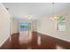 A spacious living area featuring hardwood floors, large sliding doors leading to a waterfront view, and ample natural light at 25555 Heritage Lake Blvd # 27, Punta Gorda, FL 33983