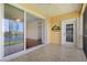Screened-in lanai with tiled floor, ceiling fan, and lake view provides a relaxing outdoor space at 25555 Heritage Lake Blvd # 27, Punta Gorda, FL 33983