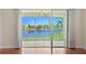 Screened-in patio offers serene water views with tile floor and a ceiling fan for a relaxed outdoor space at 25555 Heritage Lake Blvd # 27, Punta Gorda, FL 33983