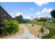 Lovely backyard features a stone paver walkway, a fire pit, and tropical landscaping at 26125 Copiapo Cir, Punta Gorda, FL 33983
