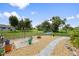 Spacious backyard with a stone fire pit area, lush landscaping, and decorative plants at 26125 Copiapo Cir, Punta Gorda, FL 33983