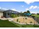 Beautiful backyard with screened pool, a fire pit, and lush landscaping with rock borders at 26125 Copiapo Cir, Punta Gorda, FL 33983