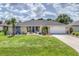 Charming home with well-manicured lawn, lovely landscaping, and an attached two-car garage at 26125 Copiapo Cir, Punta Gorda, FL 33983
