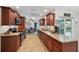 Well-equipped kitchen with cherry wood cabinets, granite countertops, and modern appliances at 26125 Copiapo Cir, Punta Gorda, FL 33983