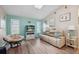 Comfortable living room with skylight, wood floors, accent wall, and charming decor at 26125 Copiapo Cir, Punta Gorda, FL 33983