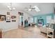 Bright living room with vaulted ceiling, skylight, wood floors, and blue accent wall at 26125 Copiapo Cir, Punta Gorda, FL 33983