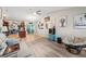 Open-concept living area showcasing wood floors, a vaulted ceiling, and art-filled decor at 26125 Copiapo Cir, Punta Gorda, FL 33983