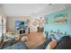 Spacious living room with comfortable seating, coastal accents, and a large television at 26125 Copiapo Cir, Punta Gorda, FL 33983