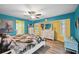 Colorful main bedroom featuring bright accent walls, lots of natural light, and wood-look floors at 26125 Copiapo Cir, Punta Gorda, FL 33983