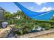 Backyard pond with lush garden and blue sun shades at 26125 Copiapo Cir, Punta Gorda, FL 33983