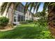 Manicured back yard with lush lawn, tropical landscaping and screened-in lanai at 2630 Tarpon Cove Dr # 212, Punta Gorda, FL 33950