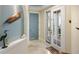 Stylish entryway featuring tiled floors, a blue accent wall, a decorative shelf, and a glass-paned front door at 2630 Tarpon Cove Dr # 212, Punta Gorda, FL 33950