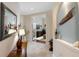 Elegant foyer with tile flooring, a decorative table, and an open view to a home office with French doors at 2630 Tarpon Cove Dr # 212, Punta Gorda, FL 33950