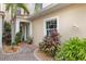 Charming entryway with lush landscaping, brick pavers, exterior lighting, and a peaceful, welcoming atmosphere at 2630 Tarpon Cove Dr # 212, Punta Gorda, FL 33950