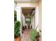 Cozy front porch with brick pavers, potted plants, and a hanging lantern, creating a welcoming entrance at 2630 Tarpon Cove Dr # 212, Punta Gorda, FL 33950