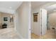 Hallway with tile flooring leading to a bathroom and featuring a decorative wall niche and wall art at 2630 Tarpon Cove Dr # 212, Punta Gorda, FL 33950